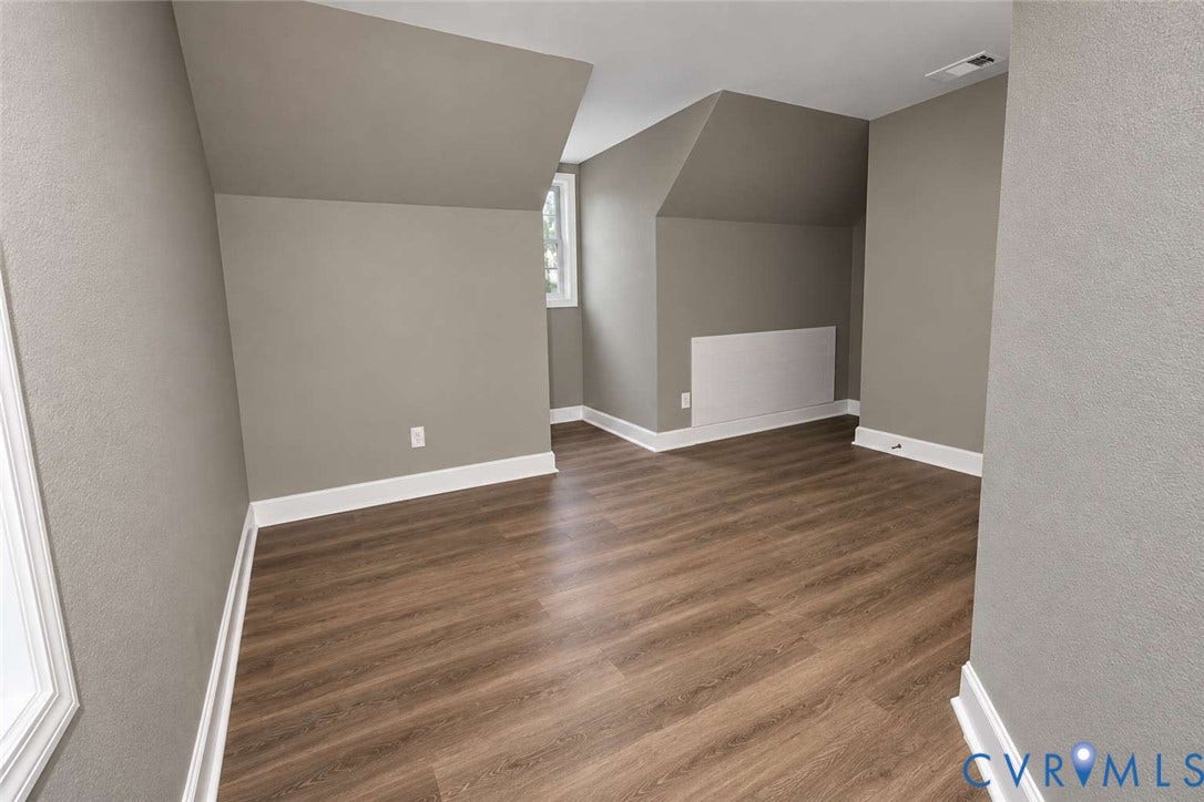 7300 Key Deer Court, Deer Run, Midlothian, VA 23112 Neutral-toned room featuring sloped ceilings, wood-finish flooring, and white window trim