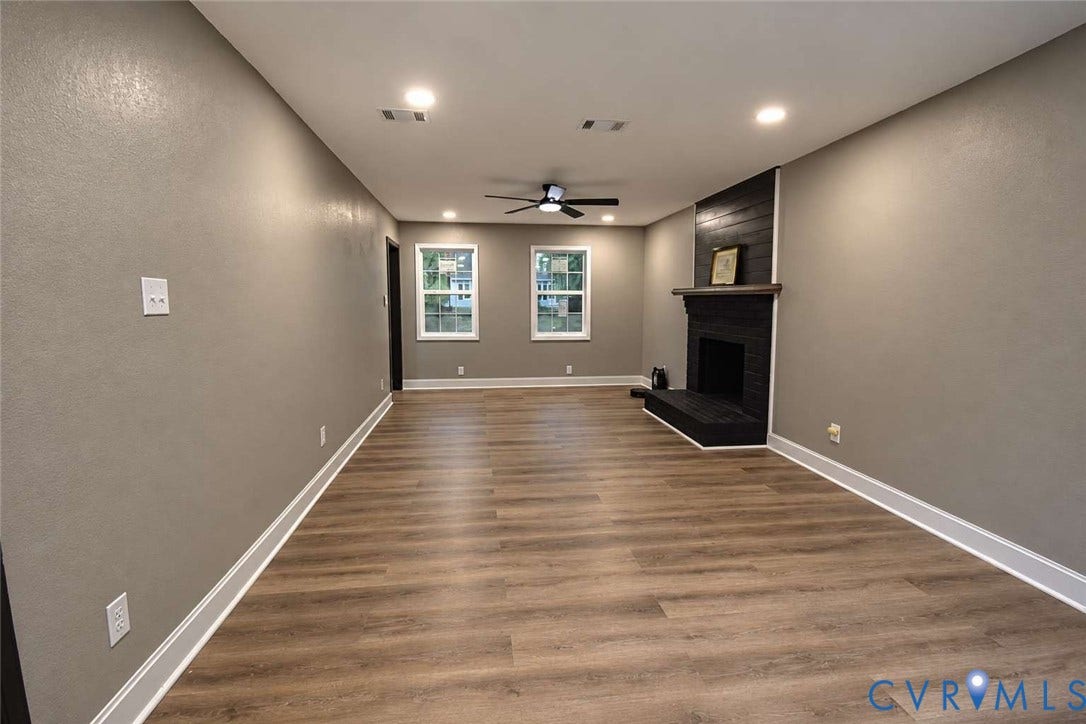7300 Key Deer Court, Deer Run, Midlothian, VA 23112 Wood-finish flooring, recessed lighting, ceiling fan, and a painted brick fireplace with a wood mantel