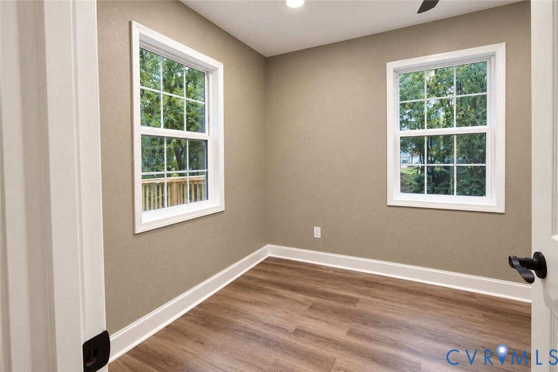 7300 Key Deer Court, Deer Run, Midlothian, VA 23112 Neutral wall tones, wood-finish flooring, recessed lighting, and double-pane windows with grid detailing