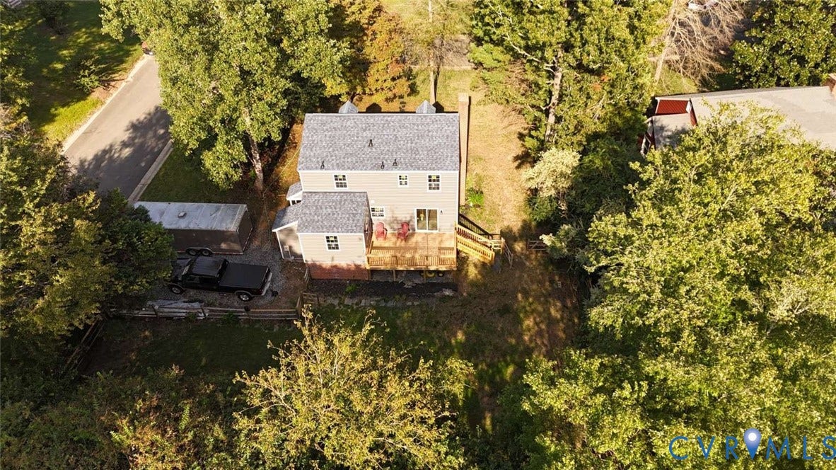 7300 Key Deer Court, Deer Run, Midlothian, VA 23112 Aerial view of a two-story residence featuring an elevated rear deck, brick foundation, asphalt shingle roof, and a wooded lot