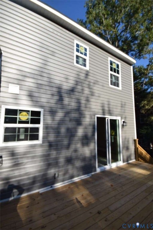 7300 Key Deer Court, Deer Run, Midlothian, VA 23112 Two-story exterior with horizontal siding, wooden deck, glass sliding patio door, and multi-pane windows