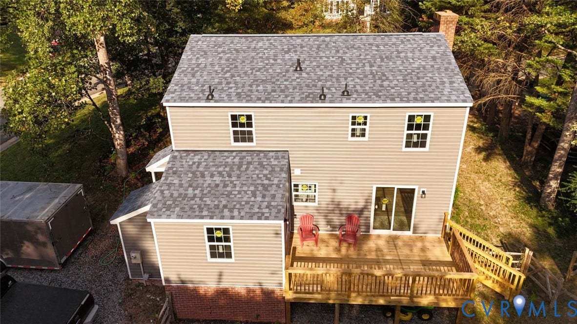 7300 Key Deer Court, Deer Run, Midlothian, VA 23112 Two-story exterior featuring horizontal siding, a composite shingle roof, a brick foundation base, and a raised wooden deck with a staircase