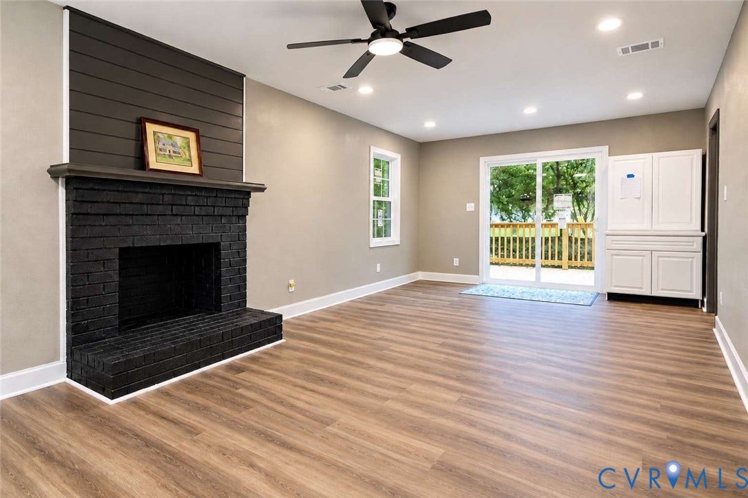 7300 Key Deer Court, Deer Run, Midlothian, VA 23112 Painted brick fireplace with a horizontal shiplap accent wall, wood-finish flooring, recessed lighting, ceiling fan, and white built-in cabinetry