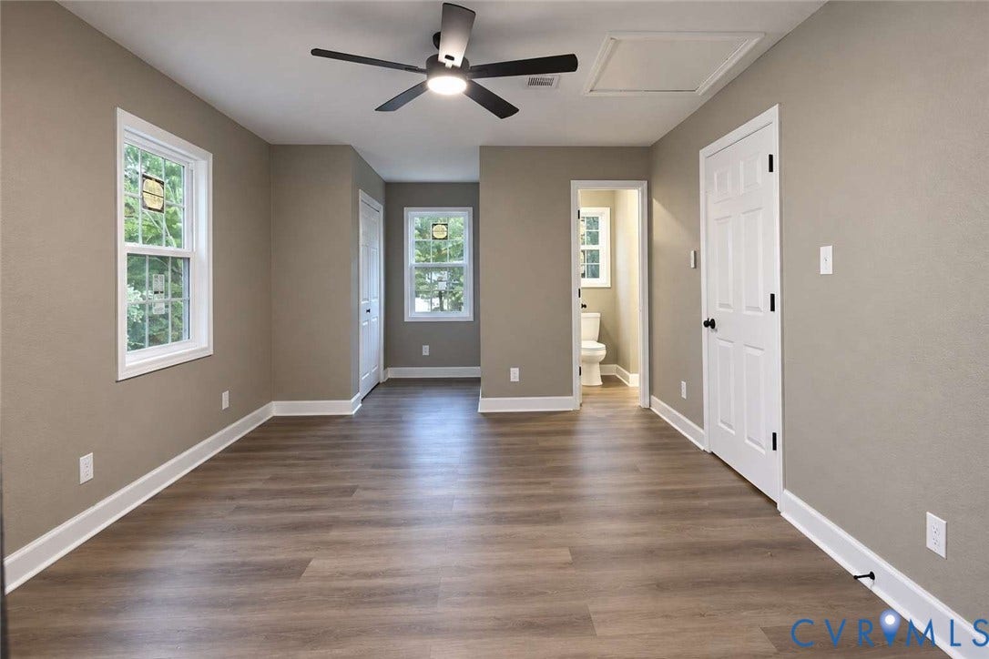 7300 Key Deer Court, Deer Run, Midlothian, VA 23112 Neutral-toned interior featuring wood-finish flooring, multi-pane windows, and a matte black ceiling fan with integrated lighting