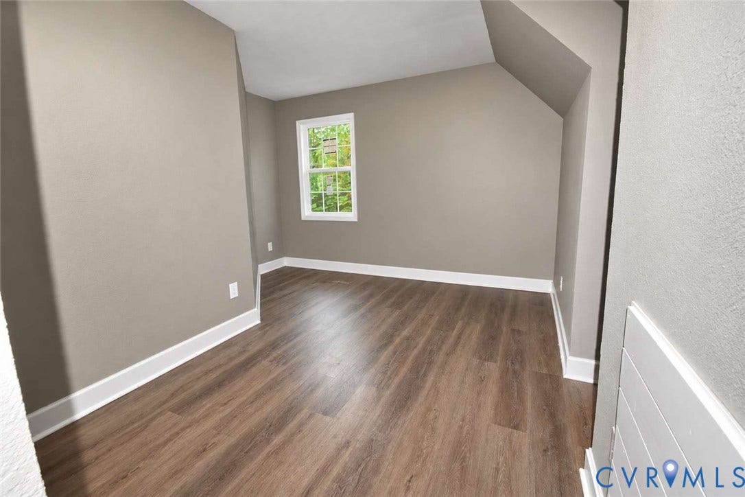 7300 Key Deer Court, Deer Run, Midlothian, VA 23112 Neutral-toned walls, wood-finish flooring, and a single-hung window with exterior greenery