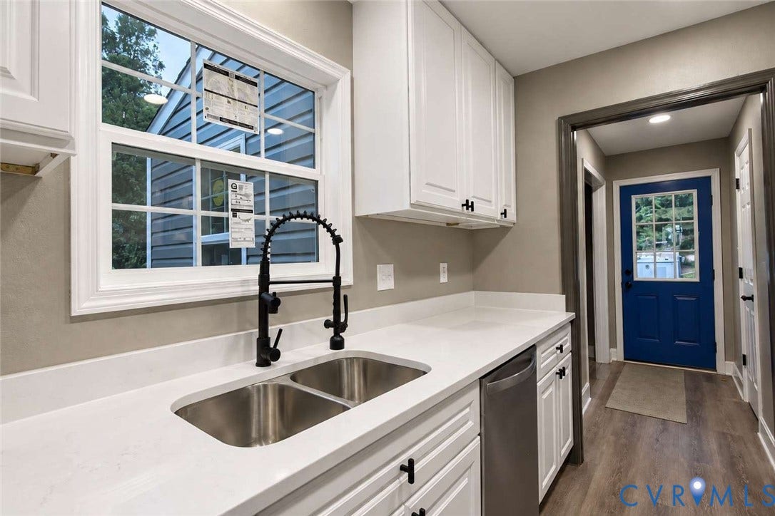 7300 Key Deer Court, Deer Run, Midlothian, VA 23112 Kitchen featuring white shaker-style cabinetry, solid-surface countertops, dual-basin stainless steel sink with matte black gooseneck faucet, and stainless steel dishwasher