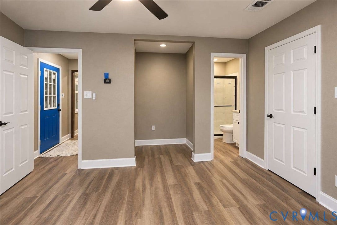 7300 Key Deer Court, Deer Run, Midlothian, VA 23112 Neutral-toned interior featuring wood-finish flooring, a recessed ceiling fan, multiple six-panel interior doors, and a blue exterior door with glass panes