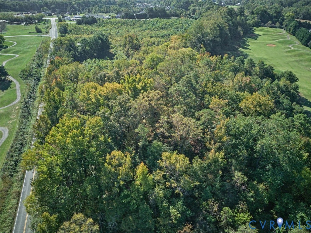 2010 Manakin Road, Sycamore Creek, Goochland, VA 23103 Expansive wooded lot featuring mature trees, direct paved road access, and proximity to maintained fairways