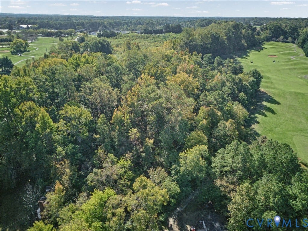 2010 Manakin Road, Sycamore Creek, Goochland, VA 23103 Expansive lot featuring mature deciduous and coniferous trees, dense woodland foliage, and direct proximity to manicured course grounds