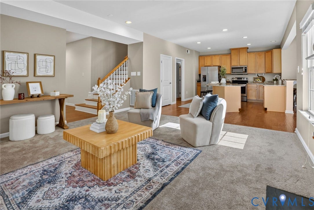 10851 White Dogwood Drive, Oakmont Villas, New Kent, VA 23140 Open-concept interior featuring wood-finish flooring, a kitchen with natural wood cabinetry and a central island, recessed lighting, and a staircase with a wooden handrail