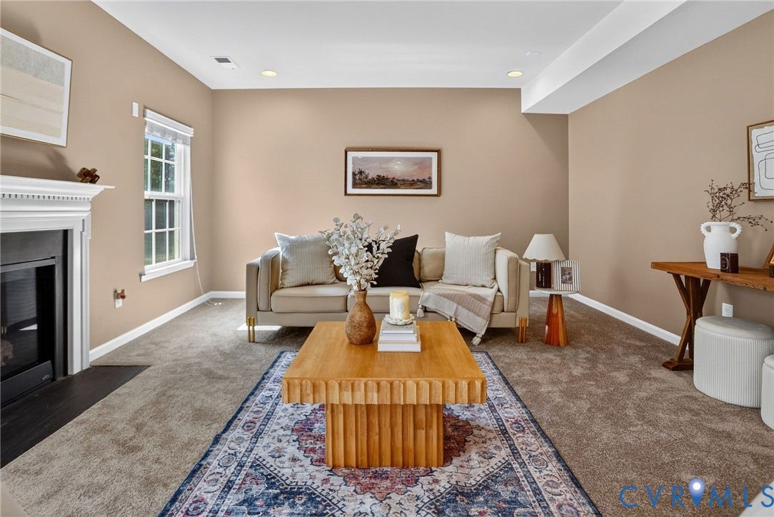 10851 White Dogwood Drive, Oakmont Villas, New Kent, VA 23140 Neutral-toned living space featuring wall-to-wall carpeting, a fireplace with a decorative mantel, recessed ceiling lighting, and a window with trim detail