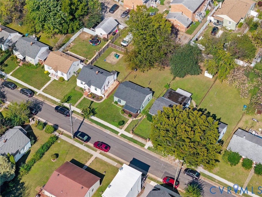 1826 Claiborne Street, Byrd Park, Richmond, VA 23220 Aerial perspective featuring a residential lot with a grassy backyard, mature shade trees, and perimeter fencing