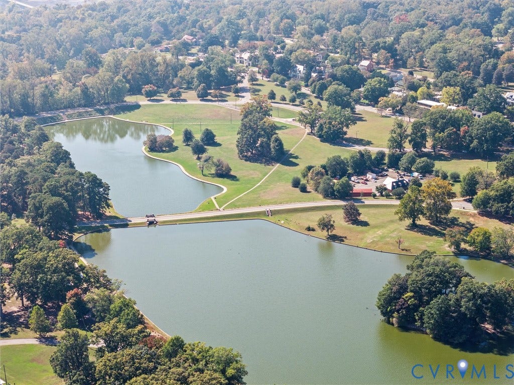 1826 Claiborne Street, Byrd Park, Richmond, VA 23220 Aerial view of multi-acre grounds featuring dual ponds, mature woodland canopy, expansive open lawn spaces, and winding paved paths