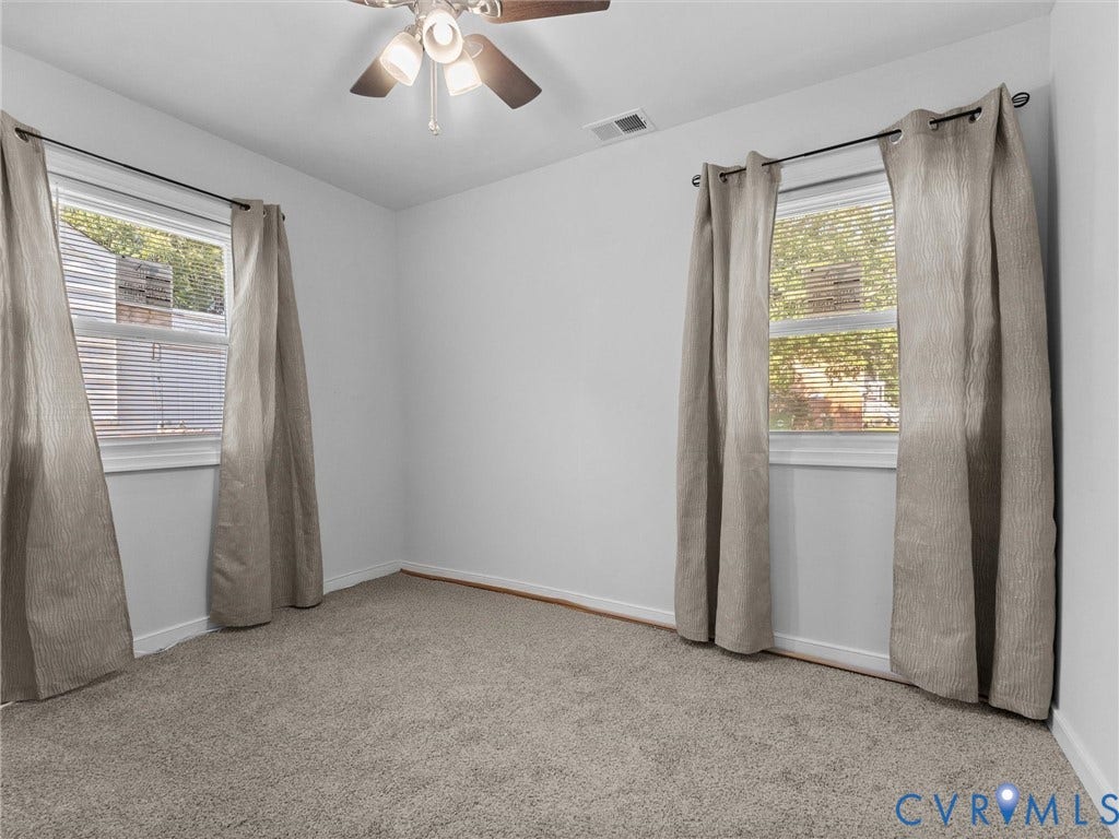 1826 Claiborne Street, Byrd Park, Richmond, VA 23220 Room featuring neutral-toned carpeting, two windows with white trim, and a ceiling-mounted light fixture with a fan