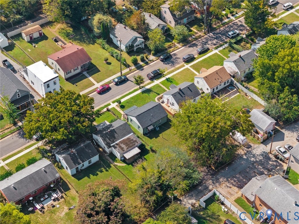 1826 Claiborne Street, Byrd Park, Richmond, VA 23220 Aerial perspective of a detached residential property featuring a green-toned exterior, asphalt shingle roof, established shade trees, and a grass-covered backyard