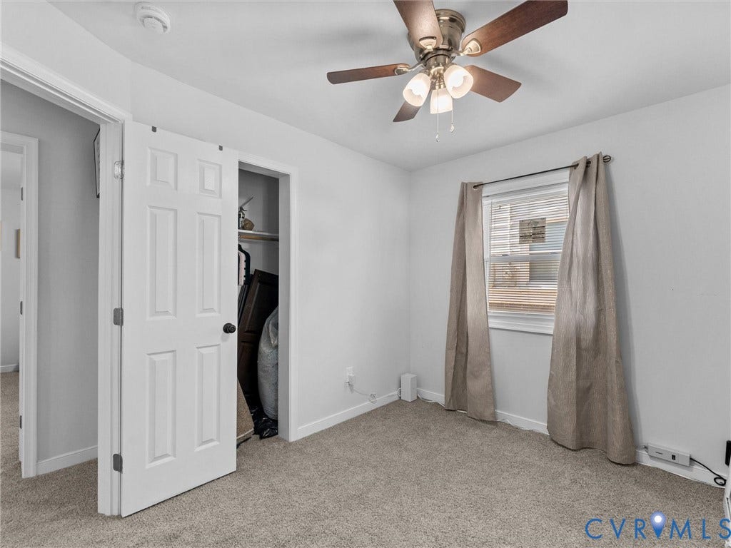1826 Claiborne Street, Byrd Park, Richmond, VA 23220 Room featuring carpeted flooring, neutral wall coloring, a multi-blade ceiling fan with integrated lighting, a single-window configuration, and a built-in closet with a swinging paneled door
