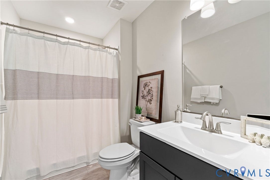 Lot 2 Summer Meadow Road, Beaverdam, VA 23015 Bathroom featuring a dark-toned vanity, white countertop with integrated sink, brushed-nickel faucet, and a large frameless mirror