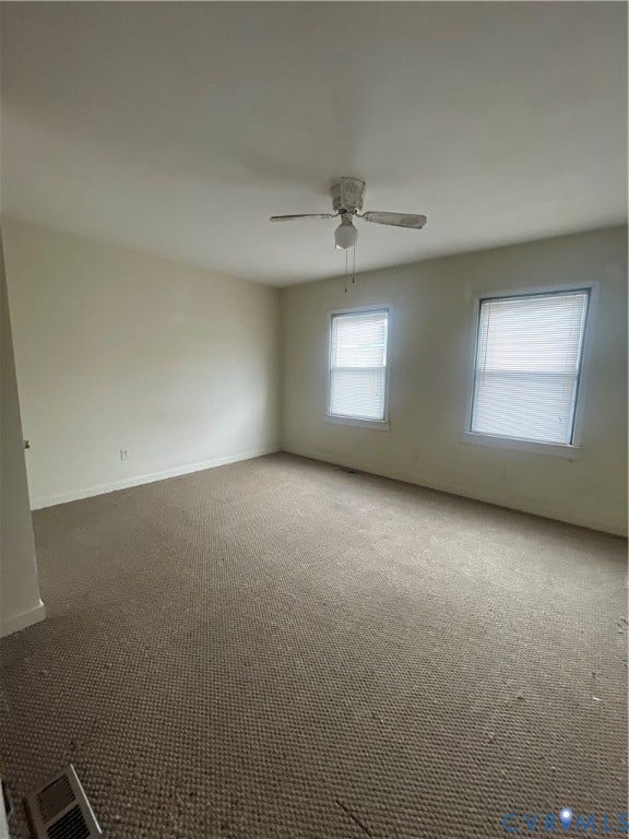 1214 N 30th Street, Richmond, VA 23223 Neutral-toned interior featuring wall-to-wall carpeting, two windows with blinds, and a ceiling fan