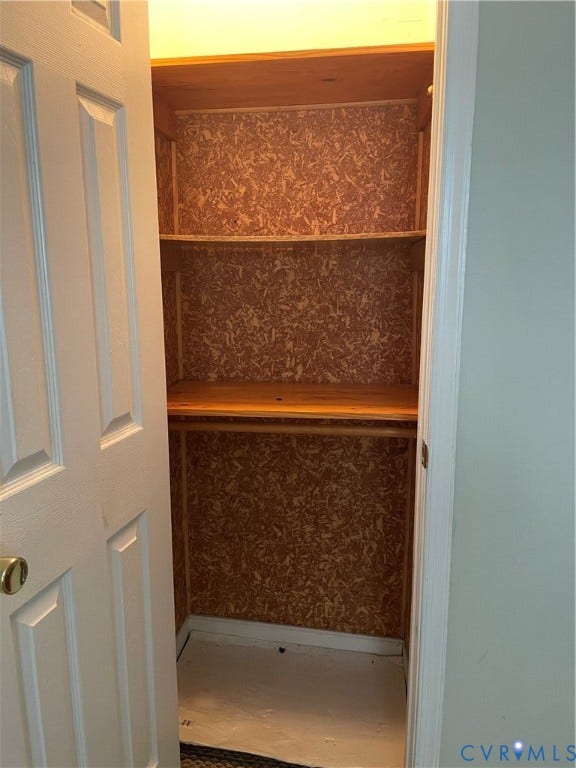 1214 N 30th Street, Richmond, VA 23223 Storage closet featuring a six-panel door, built-in shelving, and a hanging rod