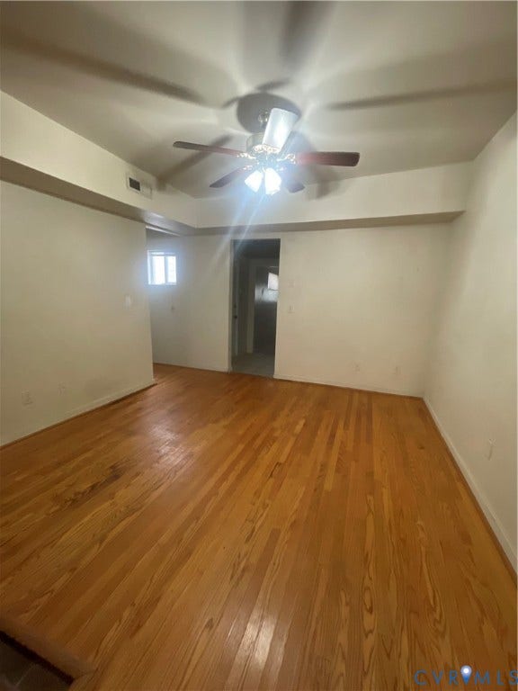 1214 N 30th Street, Richmond, VA 23223 Interior space featuring wood-finish flooring, recessed ceiling detailing, and a central ceiling fan with integrated lighting