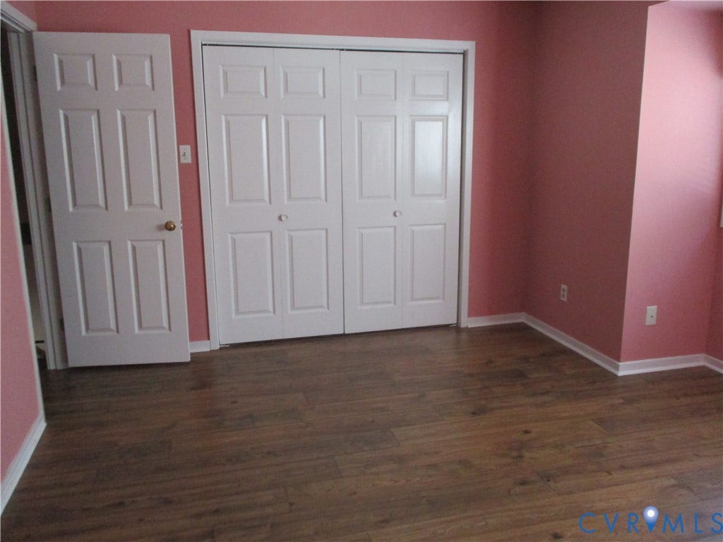 12400 New Point Drive, Wilde Lake, Henrico, VA 23233 Room interior featuring wood-finish flooring, double-panel closet doors, and a standard interior swinging door