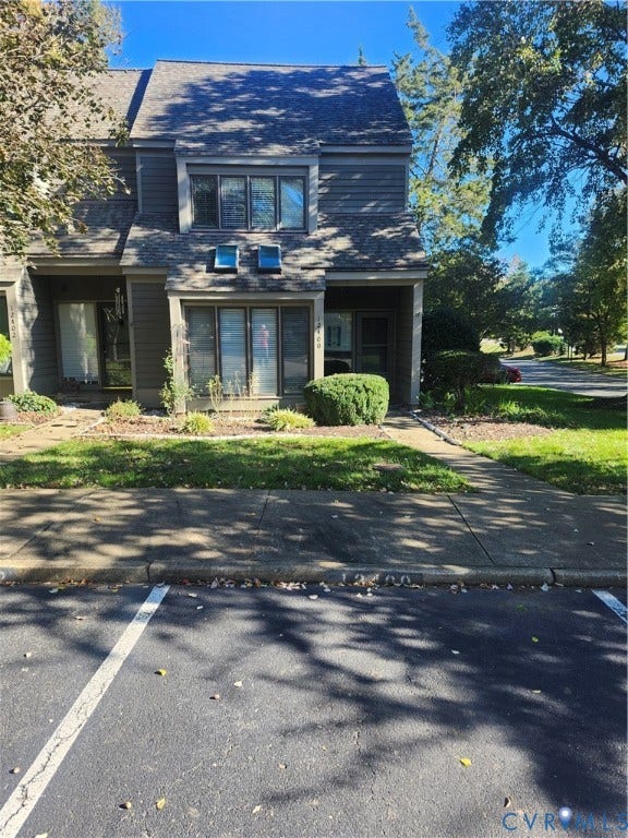 12400 New Point Drive, Wilde Lake, Henrico, VA 23233 Multi-level exterior featuring horizontal siding, a gabled roof, two roof-mounted skylights, a large bay window, and a concrete walkway