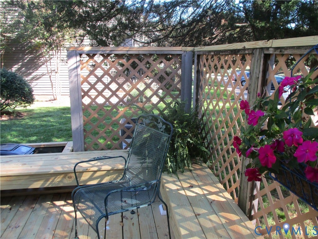 12400 New Point Drive, Wilde Lake, Henrico, VA 23233 Outdoor deck featuring pressure-treated lumber decking, built-in bench seating, and wood lattice privacy screening