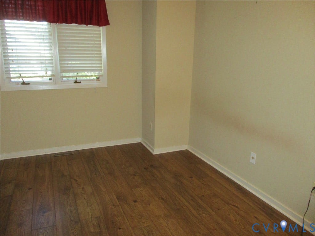 12400 New Point Drive, Wilde Lake, Henrico, VA 23233 Interior room featuring wood-finish flooring and double-hung window with horizontal blinds