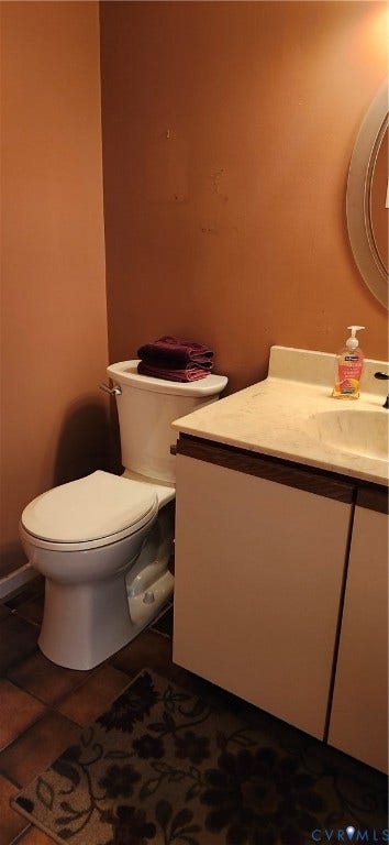 12400 New Point Drive, Wilde Lake, Henrico, VA 23233 Vanity with an integrated sink and neutral-toned countertop, paired with a standard-profile toilet and tile flooring