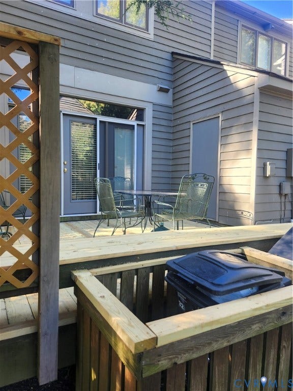12400 New Point Drive, Wilde Lake, Henrico, VA 23233 Exterior wood deck featuring horizontal lap siding, wood lattice privacy screen, and an integrated wood enclosure