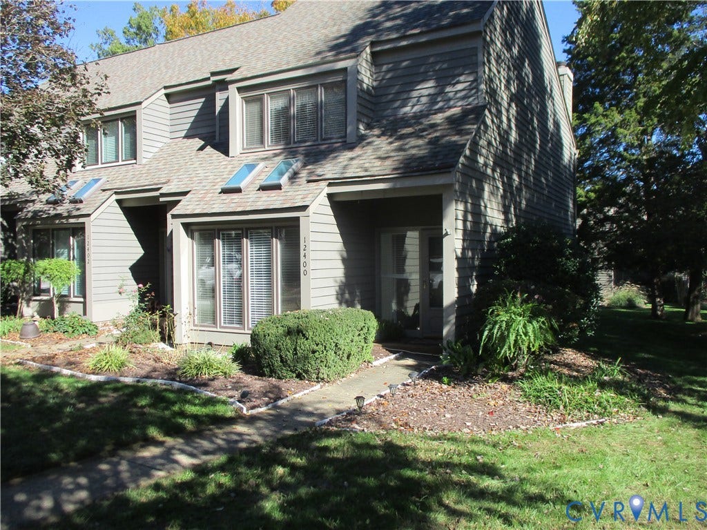 12400 New Point Drive, Wilde Lake, Henrico, VA 23233 Multi-level exterior featuring horizontal lap siding, multi-pane bay windows, skylights, and a concrete walkway