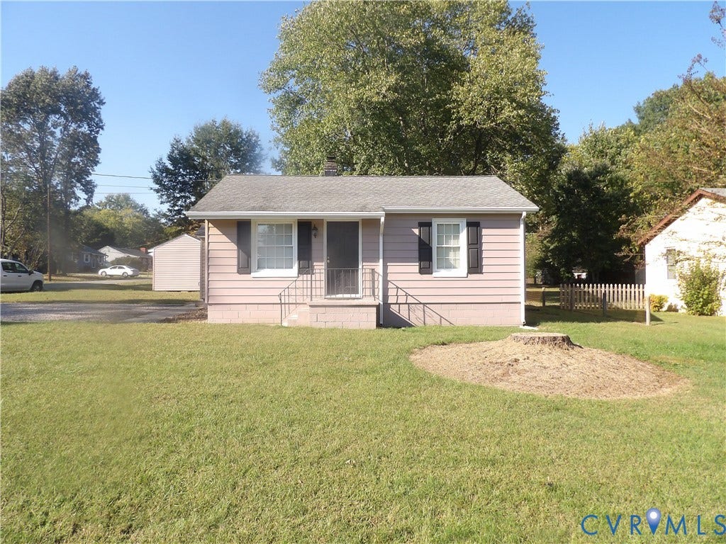 3206 South Street, Chester, VA 23831 Single-story residence featuring light-toned horizontal siding, dark decorative shutters, an asphalt shingle roof, and an open front yard