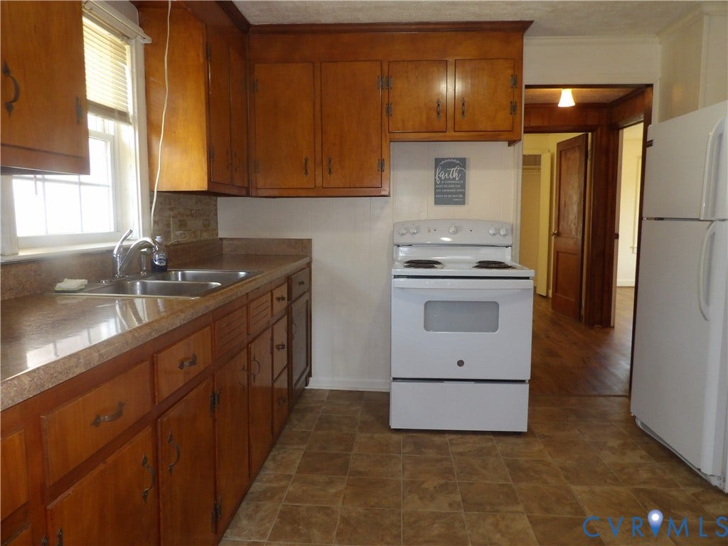 3206 South Street, Chester, VA 23831 Kitchen featuring wood cabinetry, laminate countertops, double-basin stainless steel sink, and white electric range