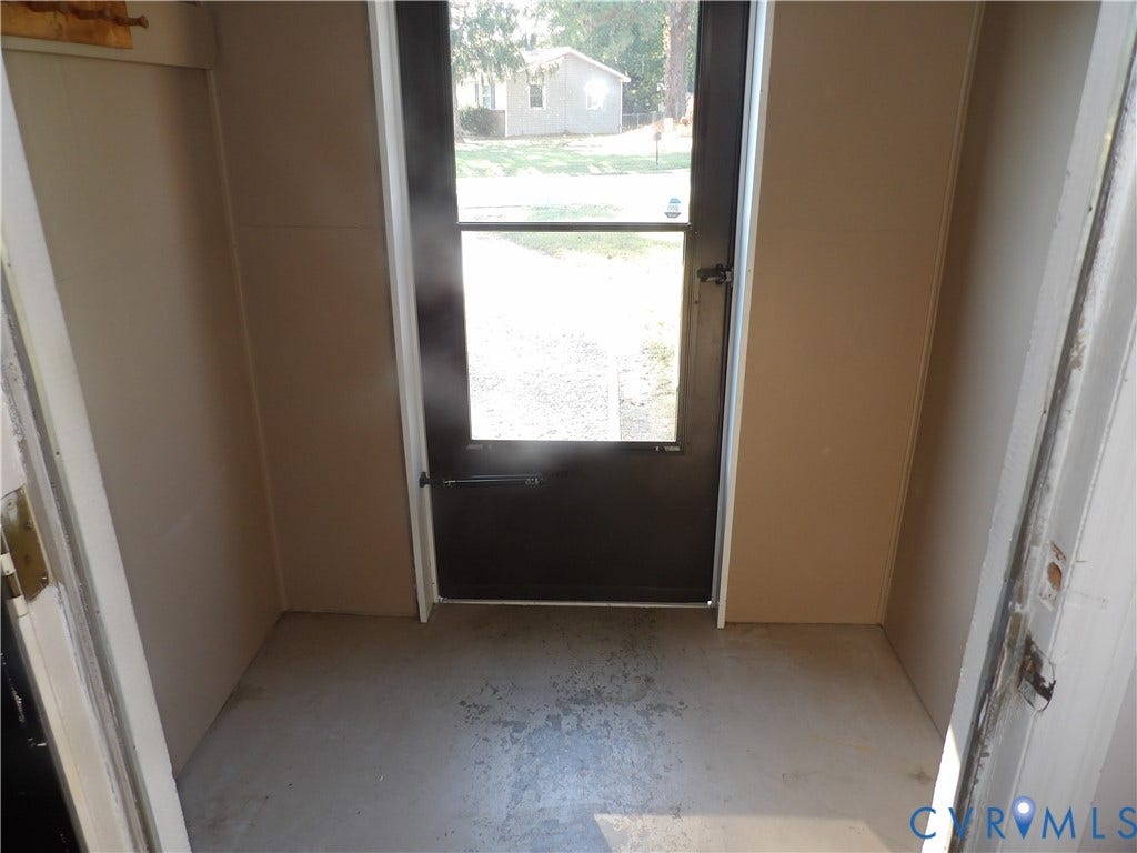 3206 South Street, Chester, VA 23831 Entryway featuring a full-light glass door with black trim and a concrete floor