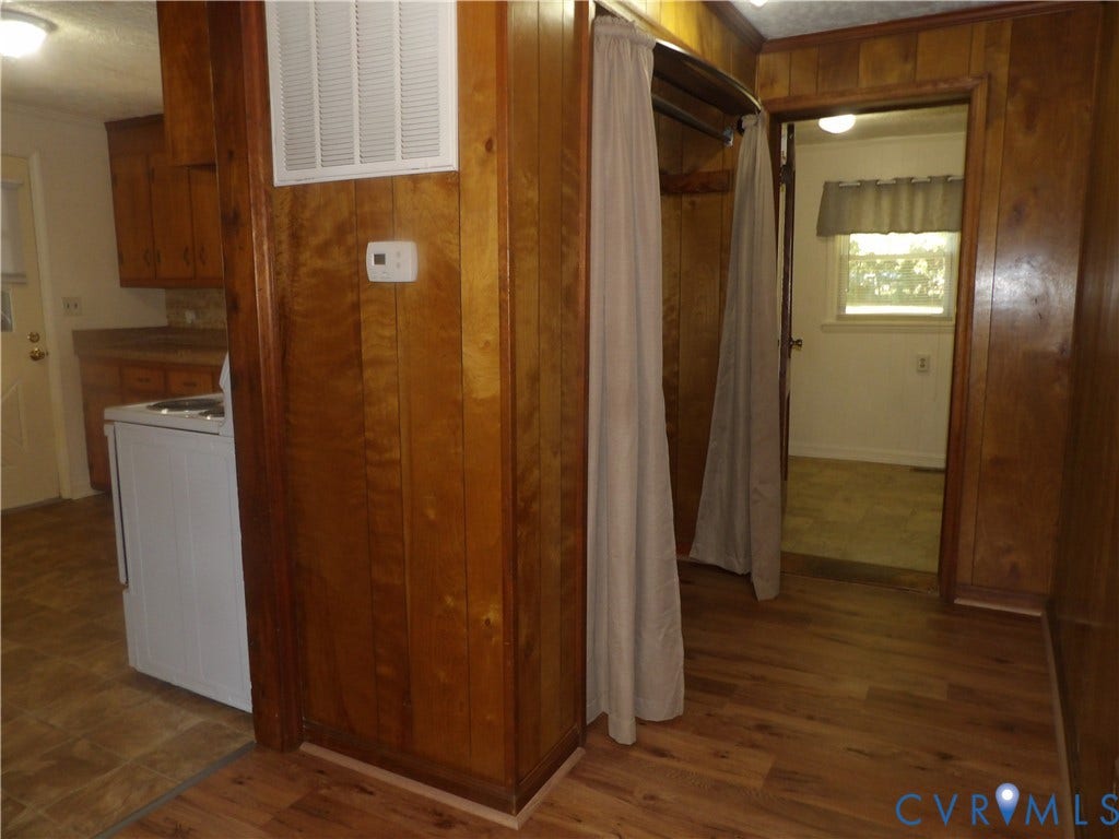 3206 South Street, Chester, VA 23831 Interior space featuring wood-paneled walls, wood-finish flooring, and built-in closet storage