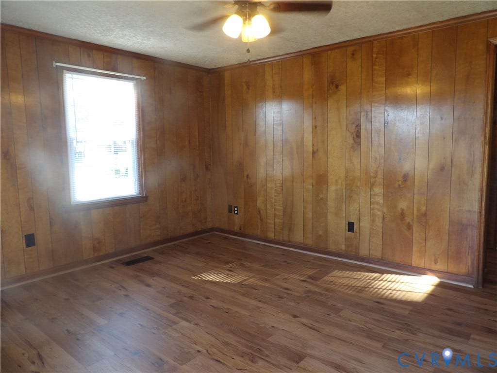 3206 South Street, Chester, VA 23831 Wood-paneled wall finishes, wood-finish flooring, and a central ceiling-mounted light fixture