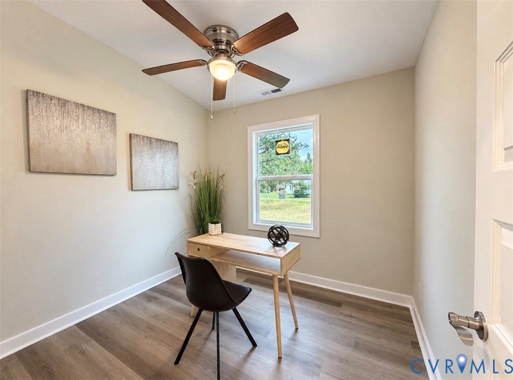 2800 Harris Hill Road, Dunnsville, VA 22454 Room featuring wood-finish flooring, a multi-blade ceiling fan with integrated lighting, and a single-hung window with white casing