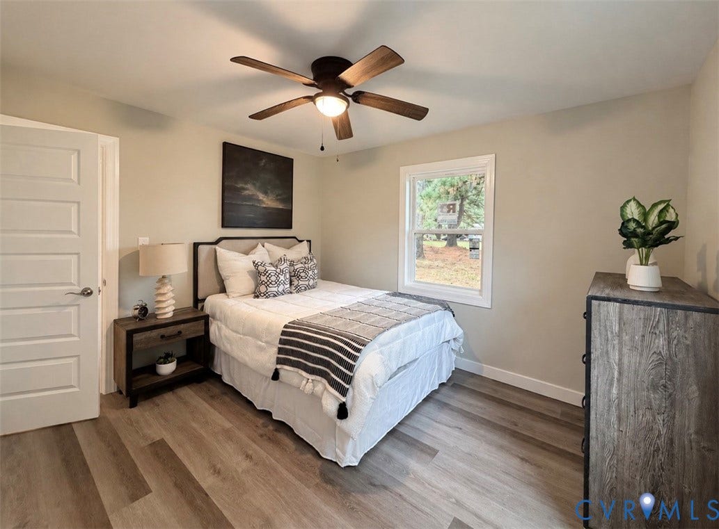 2800 Harris Hill Road, Dunnsville, VA 22454 Wood-finish flooring, multi-panel interior door, and five-blade ceiling fan with integrated lighting