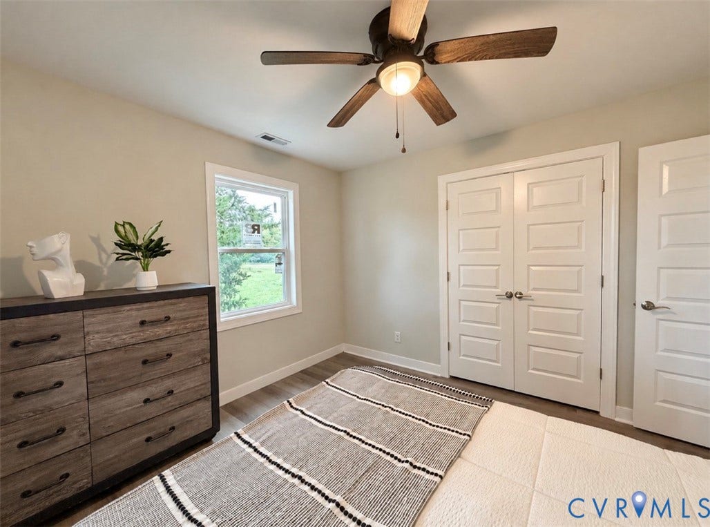 2800 Harris Hill Road, Dunnsville, VA 22454 Room featuring wood-finish flooring, a ceiling fan with integrated lighting, a single window, and multi-panel interior doors