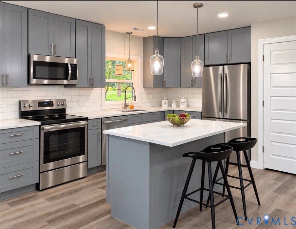 2800 Harris Hill Road, Dunnsville, VA 22454 Kitchen featuring slate-colored cabinetry, stone-finish countertops, stainless steel appliances, a central island, and wood-finish flooring