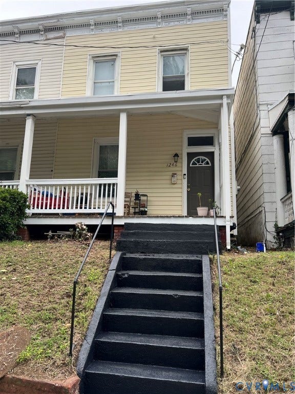 1246 Parkwood Avenue, The Fan, Richmond, VA 23220 Two-story exterior featuring light-colored horizontal siding, a covered front porch with white railing, and exterior wall-mounted lighting