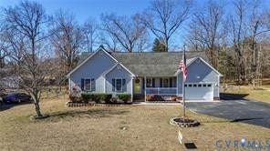 Single-story residence featuring grey lap siding, an asphalt shingle roof, a covered front porch with white railing, and an attached two-car garage