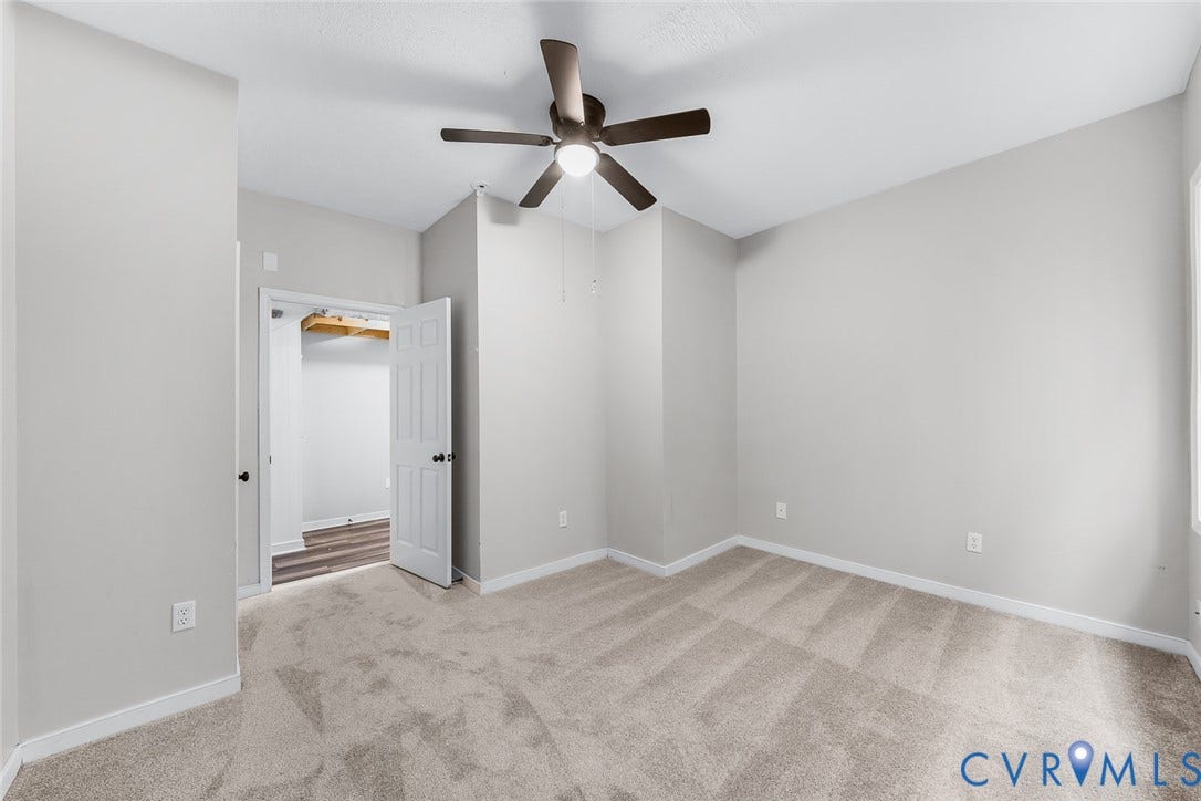 1802 Maury Street, Richmond, VA 23224 Neutral wall paint with wall-to-wall carpeting, overhead ceiling fan with integrated lighting, and six-panel interior door