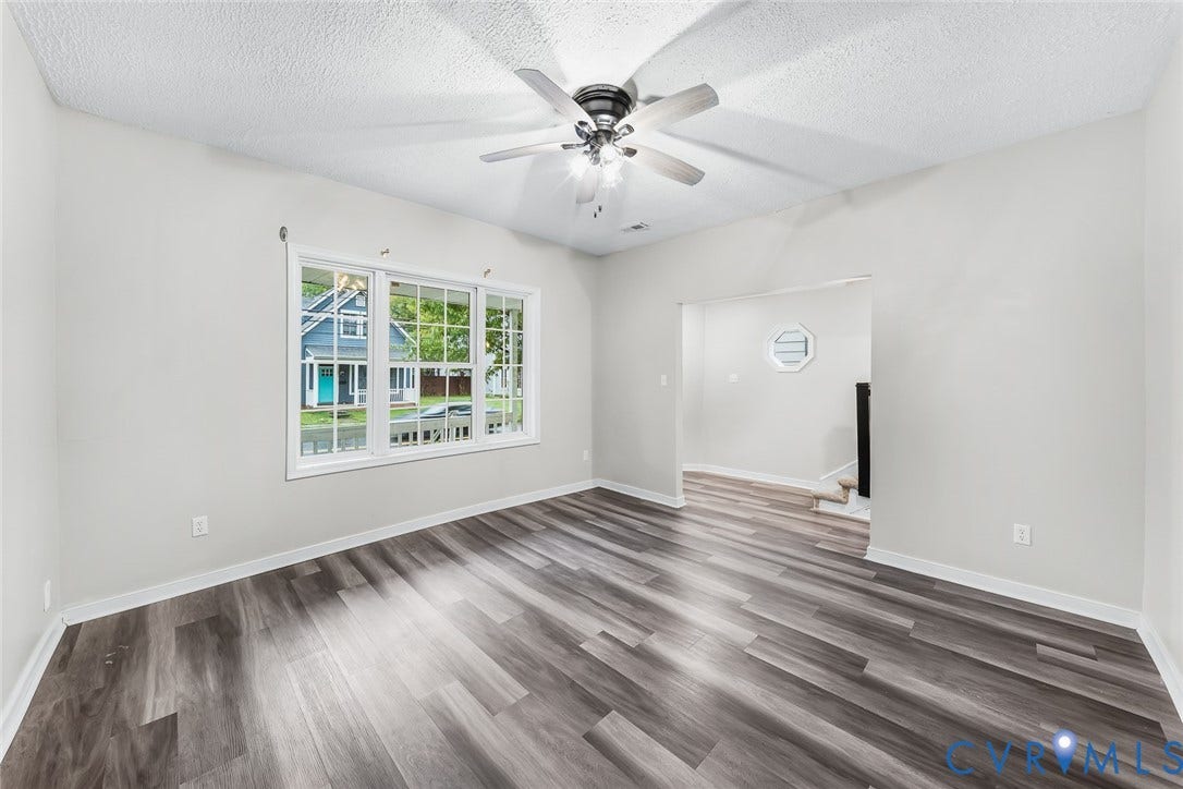 1802 Maury Street, Richmond, VA 23224 Interior space featuring wood-finish flooring, a multi-pane window, and a central ceiling fan with an integrated light fixture