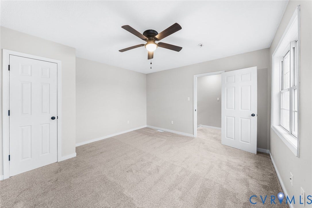 1802 Maury Street, Richmond, VA 23224 Neutral wall tones, wall-to-wall carpeting, multi-panel doors, and a ceiling fan with integrated lighting