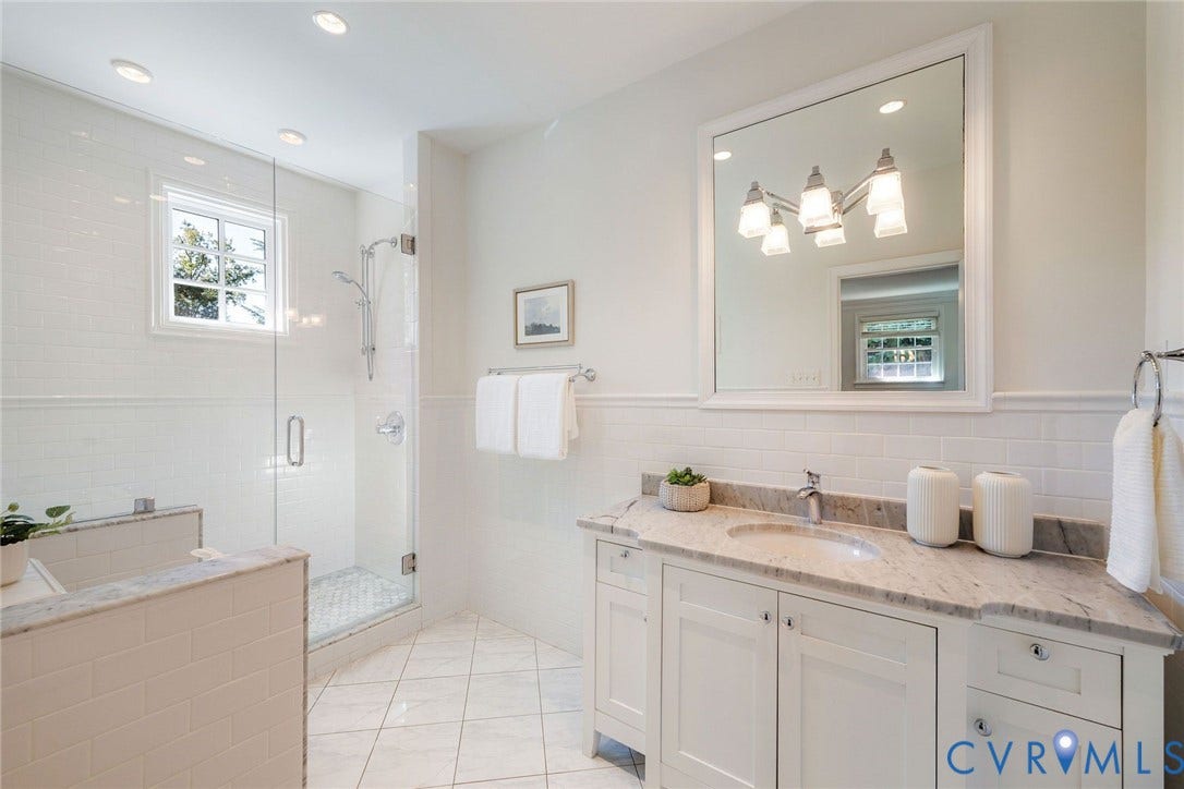 6805 River Road, Westham Ridge, Henrico, VA 23229 Serene marble and tile in the renovated primary bathroom.
