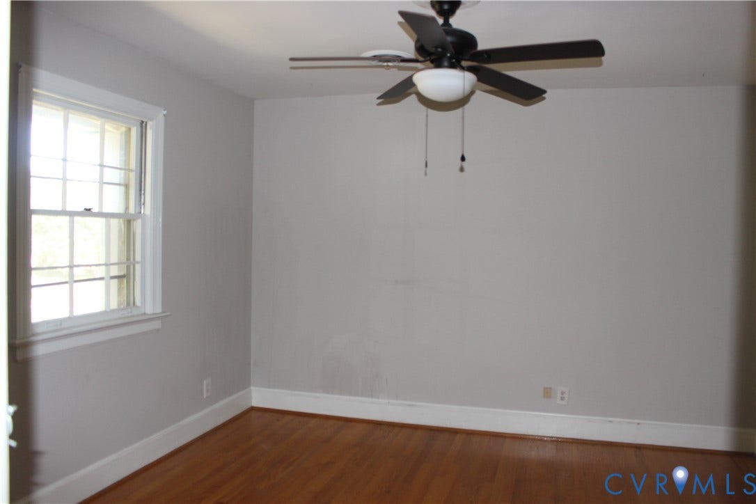 4101 Vauxhall, Chesterfield, VA 23234 Room featuring wood-finish flooring, a double-hung window with grid pattern, and a black ceiling fan with an integrated light fixture