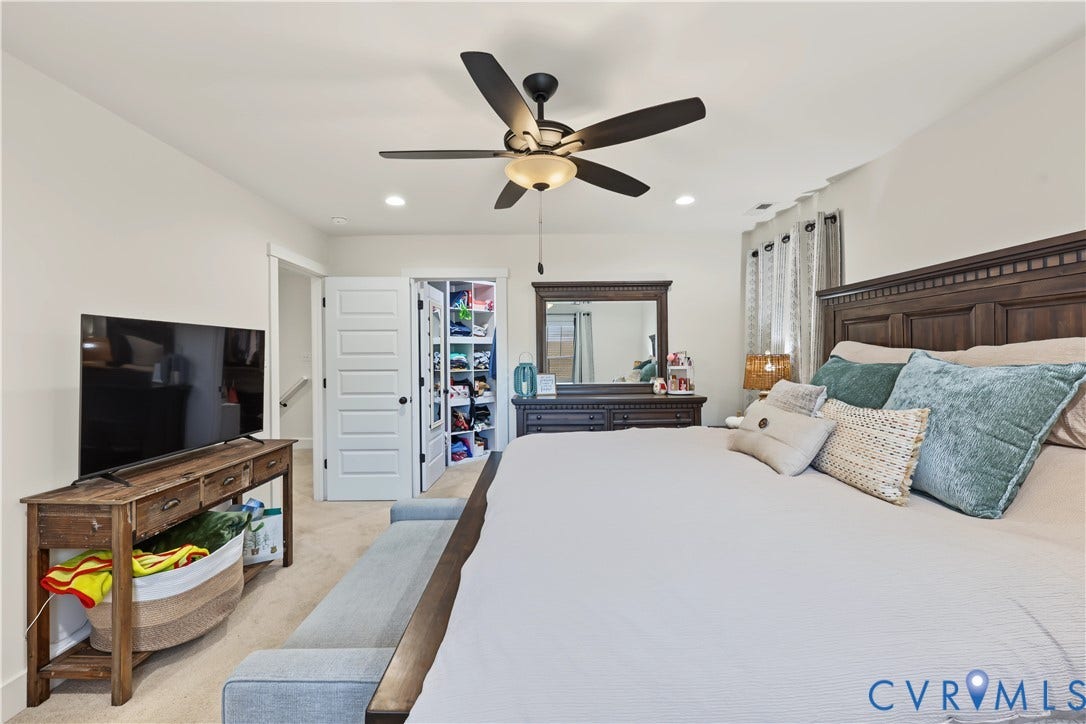 3851 County Line Road, Flemings Mill, Goochland, VA 23084 Bedroom interior featuring neutral wall paint, carpeting, recessed lighting, a five-blade ceiling fan with integrated light fixture, and a walk-in closet with built-in shelving