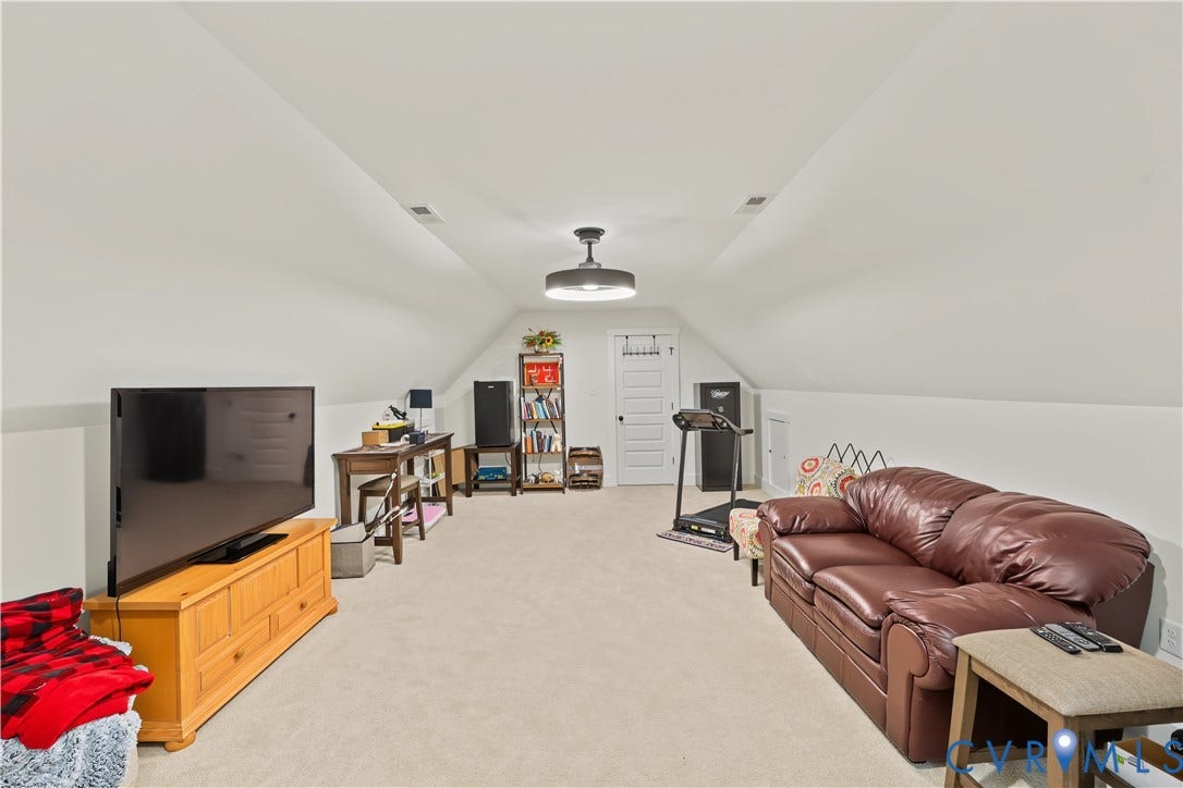 3851 County Line Road, Flemings Mill, Goochland, VA 23084 Vaulted ceilings with recessed lighting, neutral carpeting, and a multi-panel door