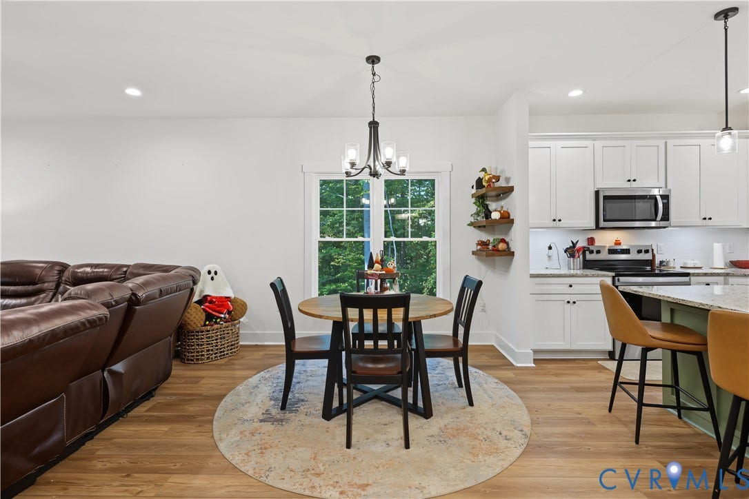 3851 County Line Road, Flemings Mill, Goochland, VA 23084 Kitchen featuring white shaker-style cabinetry, a kitchen island with stone countertops, wood-finish flooring, recessed lighting, and a multi-arm chandelier